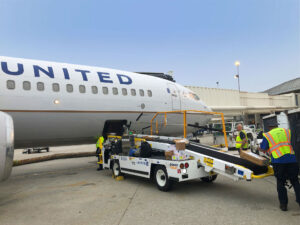 United Airlines cargo handling with Power Stow belt loader