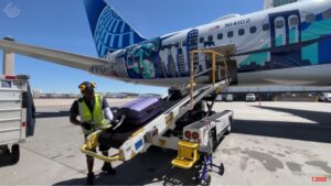 Belt loader docking on United Airlines´ plane at Denver Airport